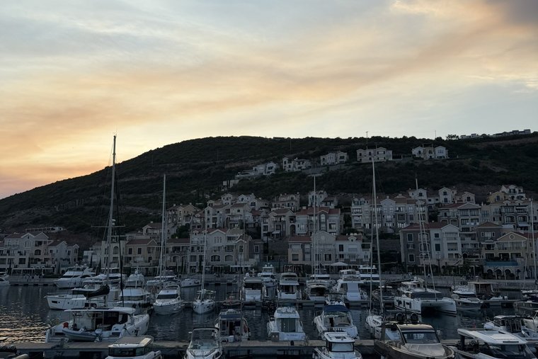 Luštica Bay marina at dusk — the planned town rising up the hillside, Luštica peninsula, Tivat